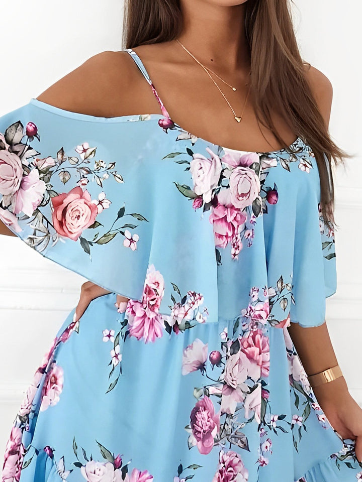 Full length front view of women's floral cold shoulder mini dress with ruffle trim, a key spring fashion.