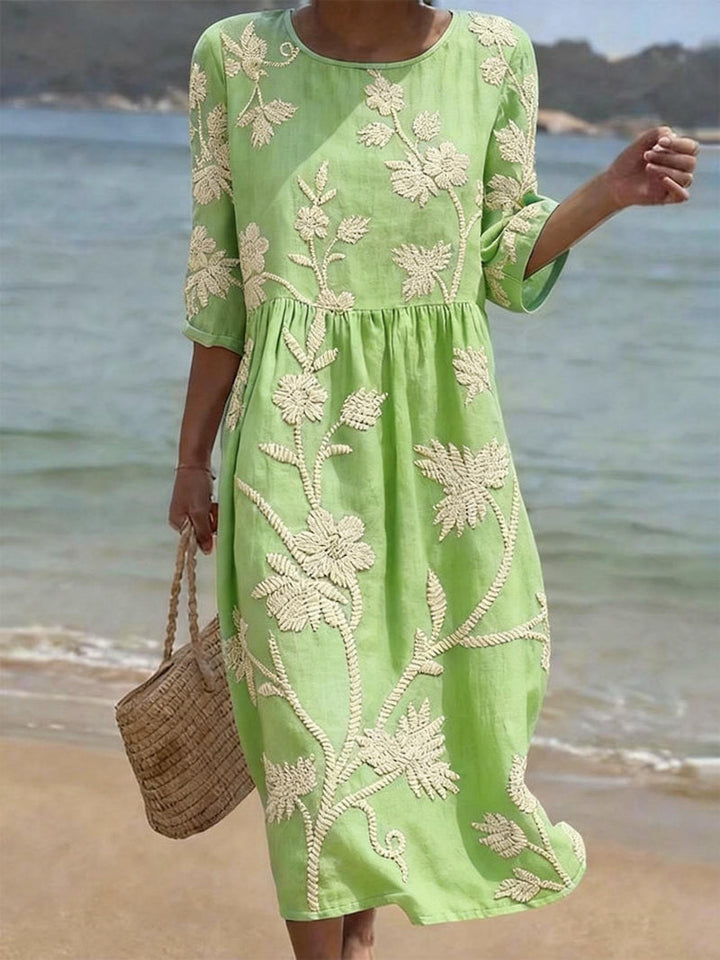 Lightweight summer midi dress with delicate floral embroidery & chic three-quarter sleeves, ideal for warm weather.
