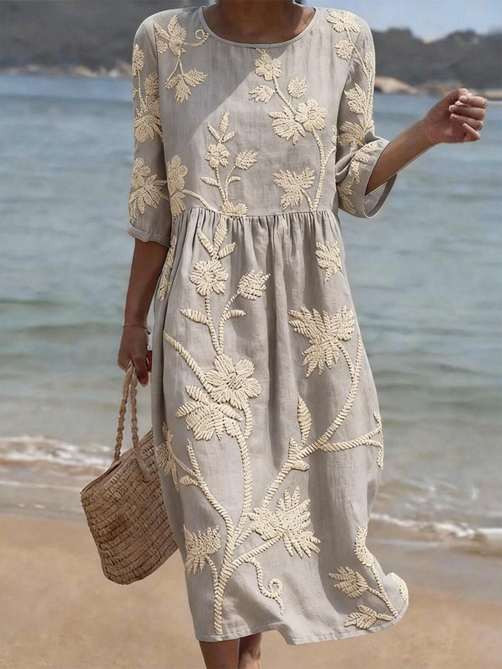Feminine day dress: women's midi with exquisite floral embroidery and comfortable three-quarter sleeves. Casual style.