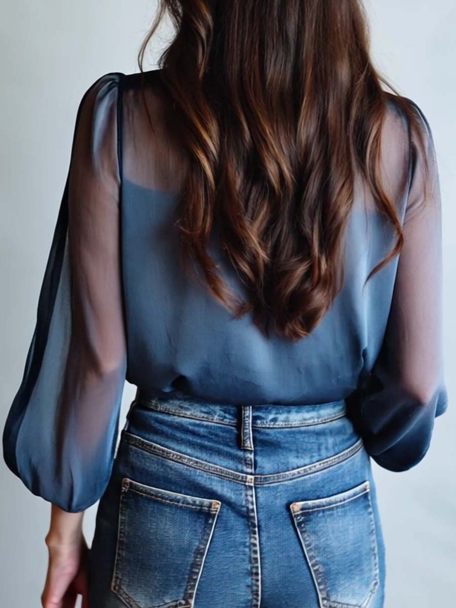 Relaxed fit women's blouse featuring floral embroidery & sheer sleeves. Comfortable & versatile.