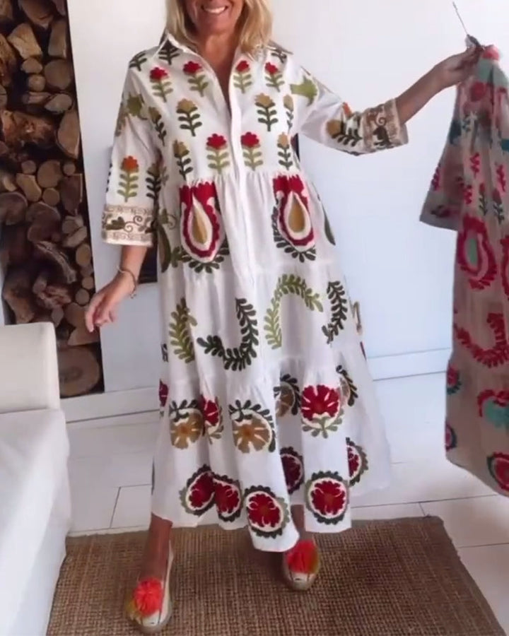 Elegant women's midi dress with a striking floral graphic print, flowy and comfortable design.