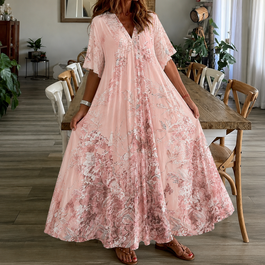 Pink floral maxi dress for women, with half sleeves & a flowy design. Great for summer, beach, or garden events.