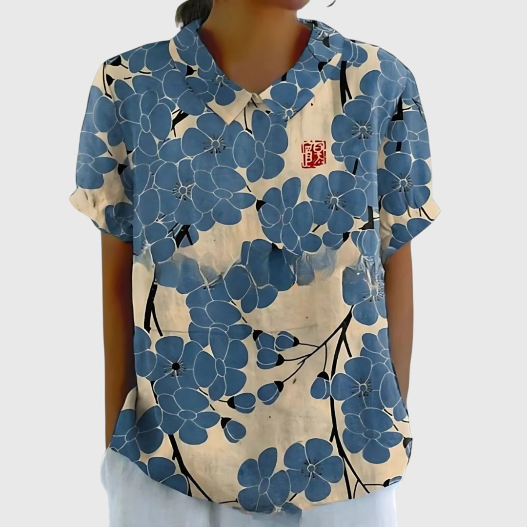 Stylish green women's floral print collared blouse. Short sleeve top, ideal for summer elegance or casual outings.