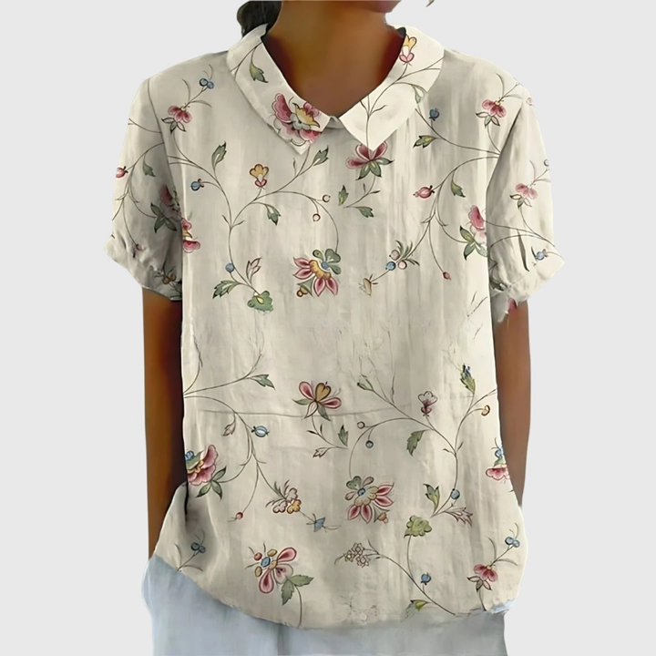 Beige women's floral print collared blouse with short sleeves. A versatile summer top for elegant casual outfits.