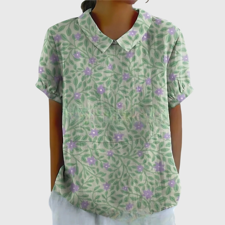 Woman modeling a chic floral print collared short sleeve blouse. Stylish summer top for versatile wear.