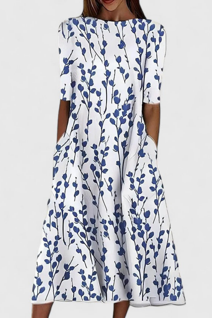 Women's floral print midi dress, relaxed A-line fit with practical pockets, perfect for summer casual wear.