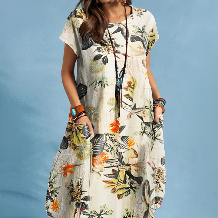 Relaxed fit women's floral print midi dress with a round neck and convenient pockets. Great for everyday summer style.