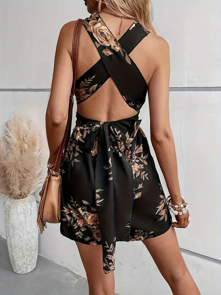 Breezy floral open-back shorts romper, ideal for resorts & casual chic.