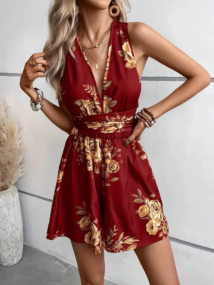 Halter neck floral open-back shorts romper, combining comfort & style.