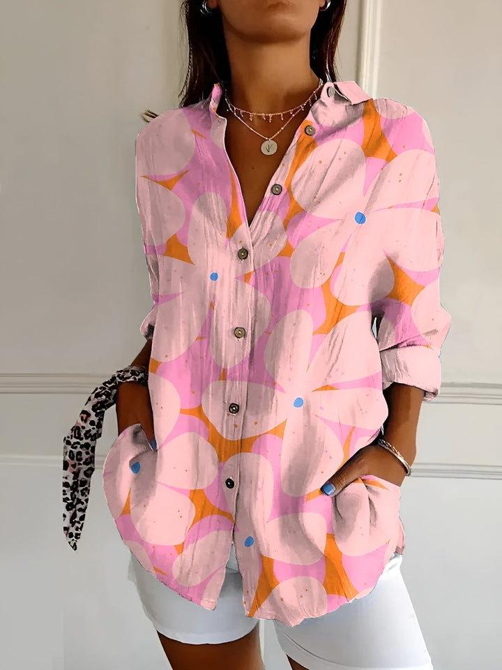 Vibrant floral print women's oversized button-down blouse. Long sleeve casual top, perfect for summer style.