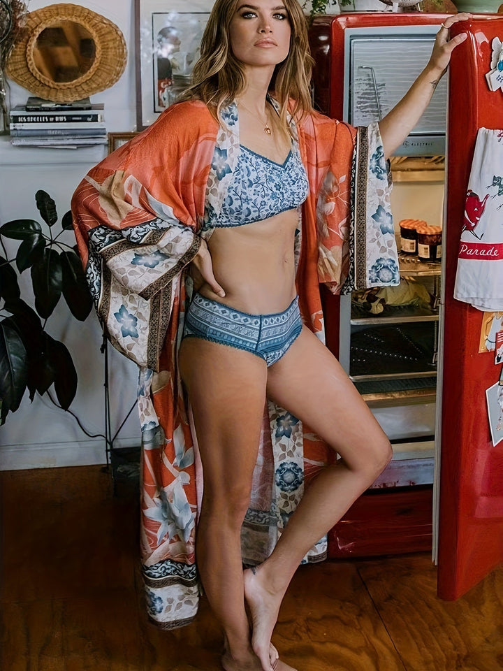 Lightweight women's kimono featuring a beautiful floral print, an effortless resort and beach style coverup.