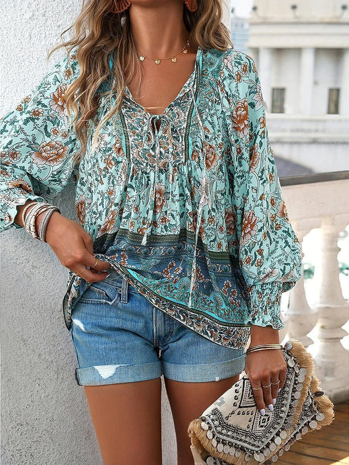 Elegant floral print puff sleeve top for women, versatile for any summer occasion.