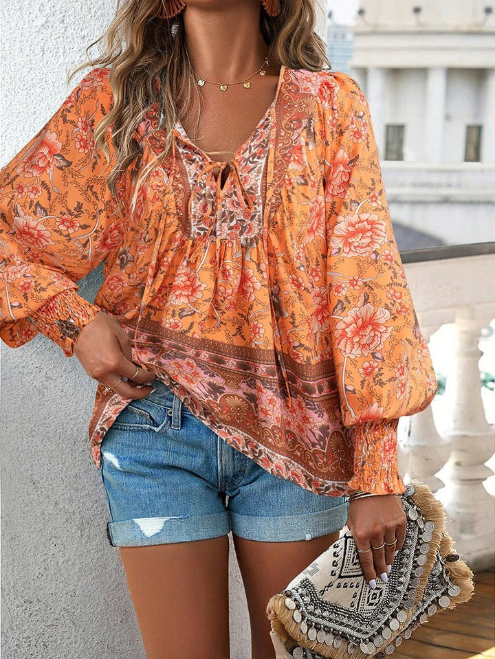 Lightweight women's summer top with delicate floral print and stylish puff sleeves.