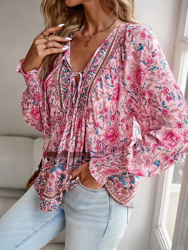 Stylish women's puff sleeve top with beautiful floral pattern, ideal for summer wear.