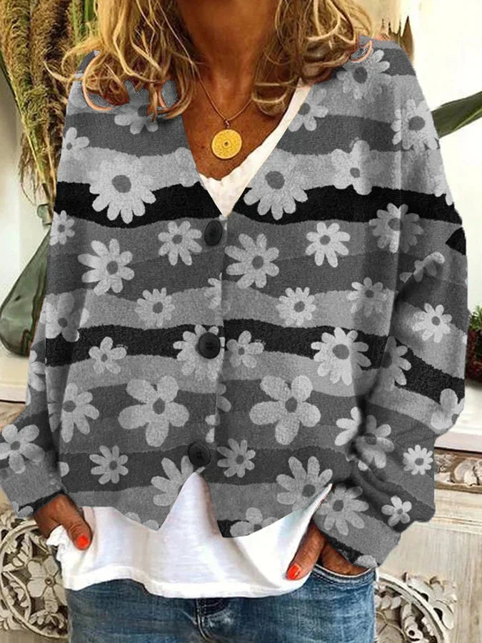 Vibrant floral stripe pattern on a women's relaxed fit button-up cardigan. Cozy knit, casual fashion.