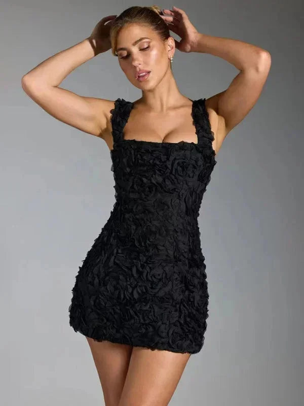 Full view of a woman wearing an elegant floral textured mini party dress, sleeveless square neck.