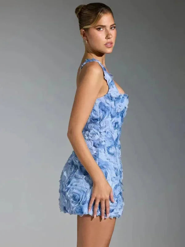 Close-up of vibrant floral textured fabric on a women's mini party dress, perfect for celebrations.