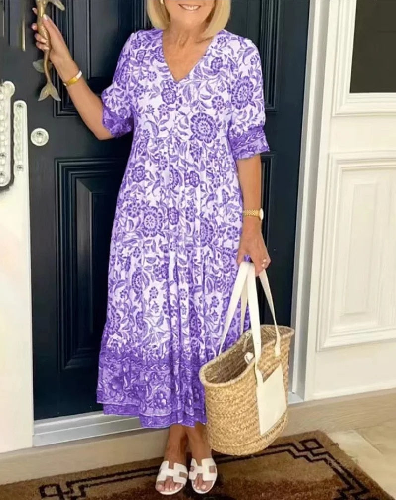 Stylish women's midi A-line dress featuring a vibrant floral print and flattering V-neck, spring summer style.