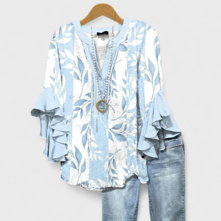 Effortless vintage floral V-neck blouse for women, featuring chic ruffled sleeves. Ideal for spring/summer fashion.