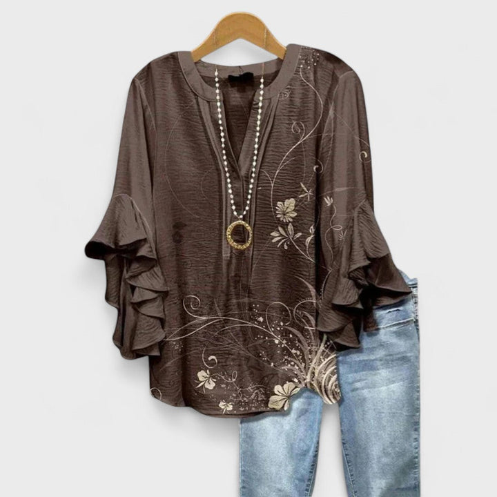 Chic women's flowy floral V-neck blouse with delicate ruffle sleeves, embodying vintage charm for any occasion.