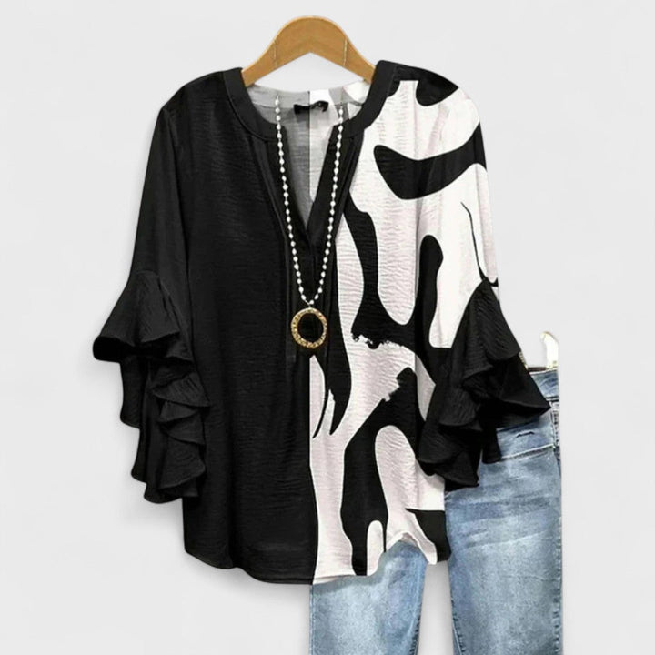 Elegant women's V-neck floral blouse with romantic ruffle sleeves, a comfortable and stylish top for daily wear.