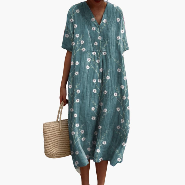 Easy-to-wear floral V-neck midi travel dress for women, featuring a relaxed fit and pockets.