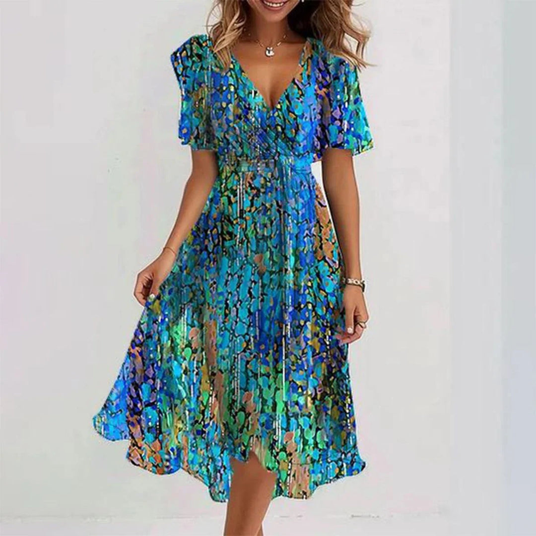 Feminine floral wrap midi dress for women. Features a flattering V-neck and flutter sleeves, perfect for summer.