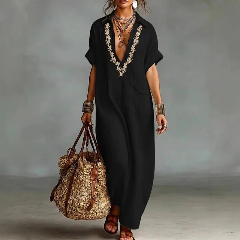 Stylish women's V-neck maxi dress with a flowy bohemian print, short sleeves, suitable for summer elegance.