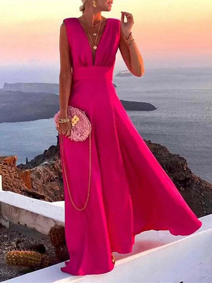 Women's flowing deep V-neck sleeveless maxi dress, perfect for elegant summer evenings or vacation wear.
