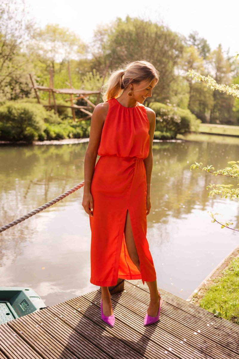 Strappy orange flowing midi dress for women. Chic & comfortable summer style, perfect for vacation.