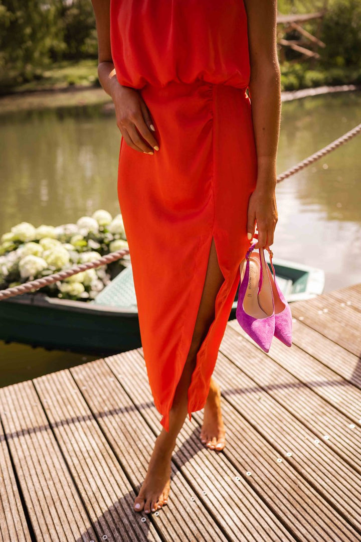 Versatile women's flowing orange midi dress. Comfortable & stylish for summer casual or elegant events.