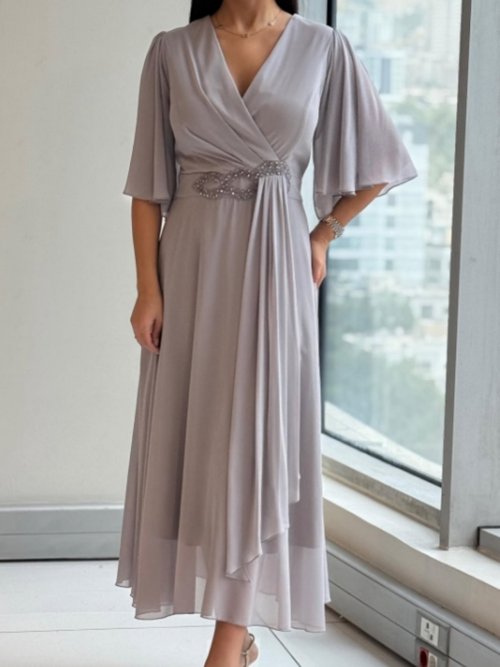 Women's flowing V-neck maxi dress with adjustable straps, perfect for summer casual or elegant resort wear.