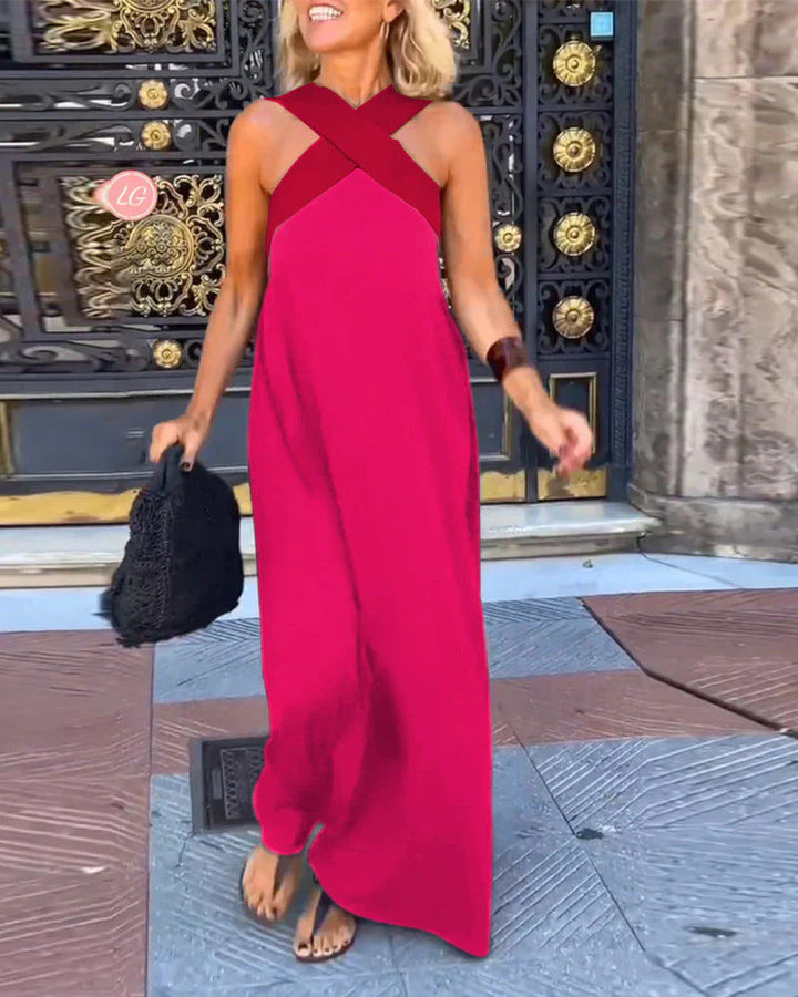 Woman wearing a flowing cross neck maxi dress, perfect for summer.