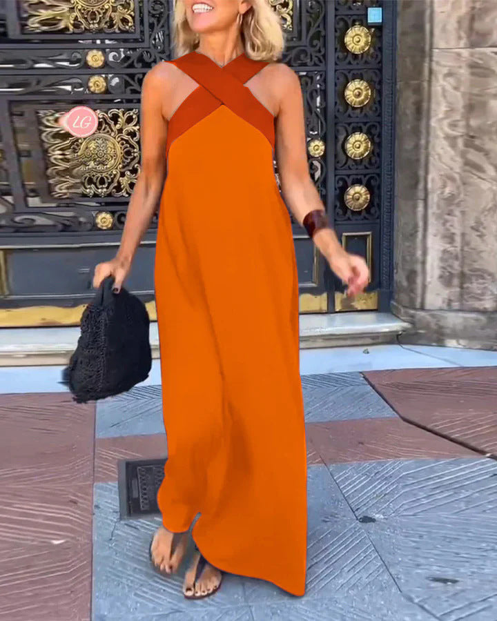 Full length shot of a women's elegant cross neck flowy maxi dress.
