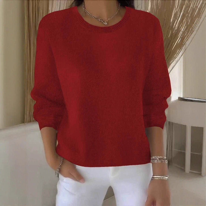 Women's flowy fit sweater for versatile, chic style. Relaxed long sleeve pullover for comfort.
