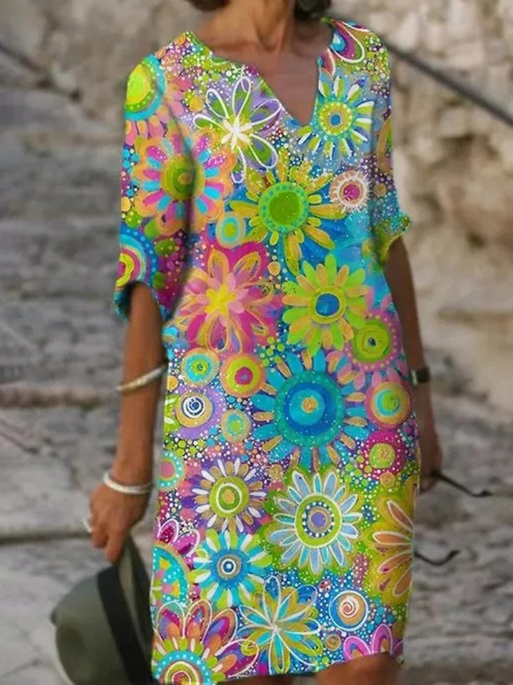 Chic women's sleeveless midi dress featuring vibrant floral print & flowy design. Ideal for summer casual elegance or vacation.