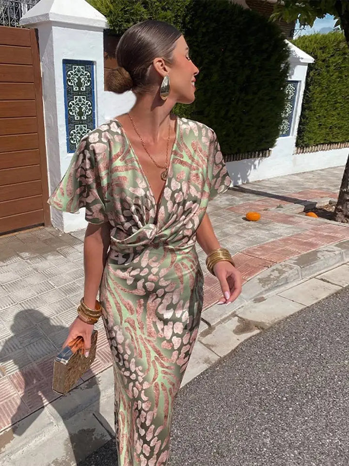 Women's flowy green abstract print wrap midi dress, relaxed fit for summer comfort & elegant occasion wear.