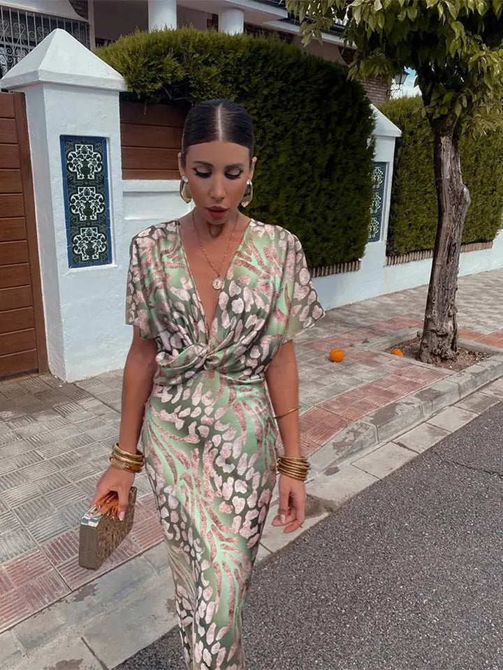 Comfortable green abstract print wrap midi dress for women, featuring a relaxed fit & elegant flowy design.