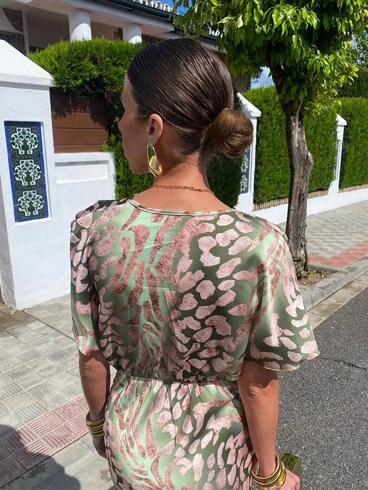 Stylish women's abstract print midi wrap dress with a relaxed, flowy fit; ideal for summer or occasion wear.