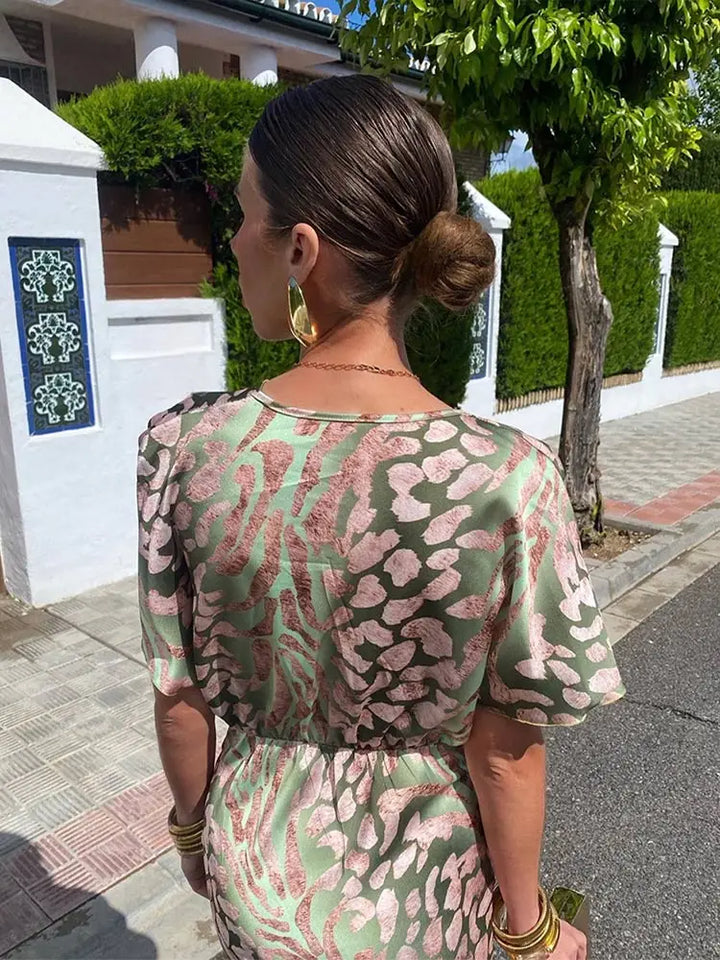 Stylish women's abstract print midi wrap dress with a relaxed, flowy fit; ideal for summer or occasion wear.