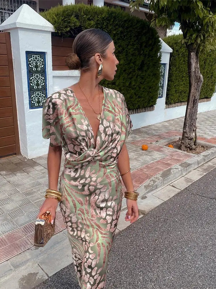 Green women's abstract print wrap midi dress, flowy and relaxed fit, perfect for elegant summer fashion.