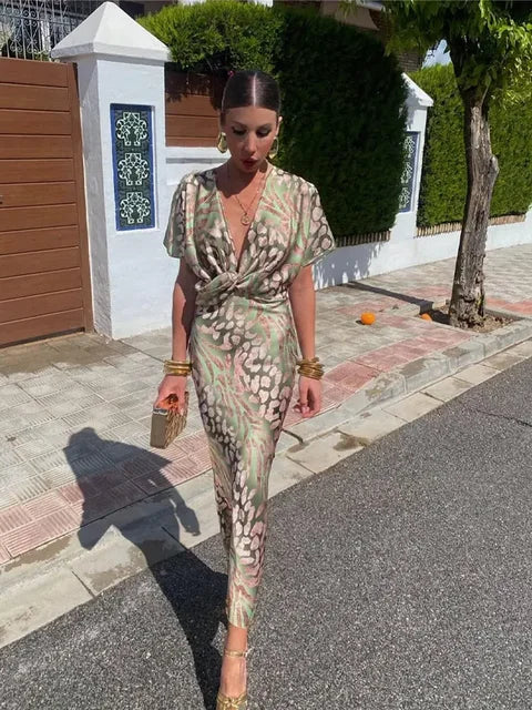 Versatile women's flowy wrap midi dress with abstract print, relaxed fit, suitable for parties or vacation.