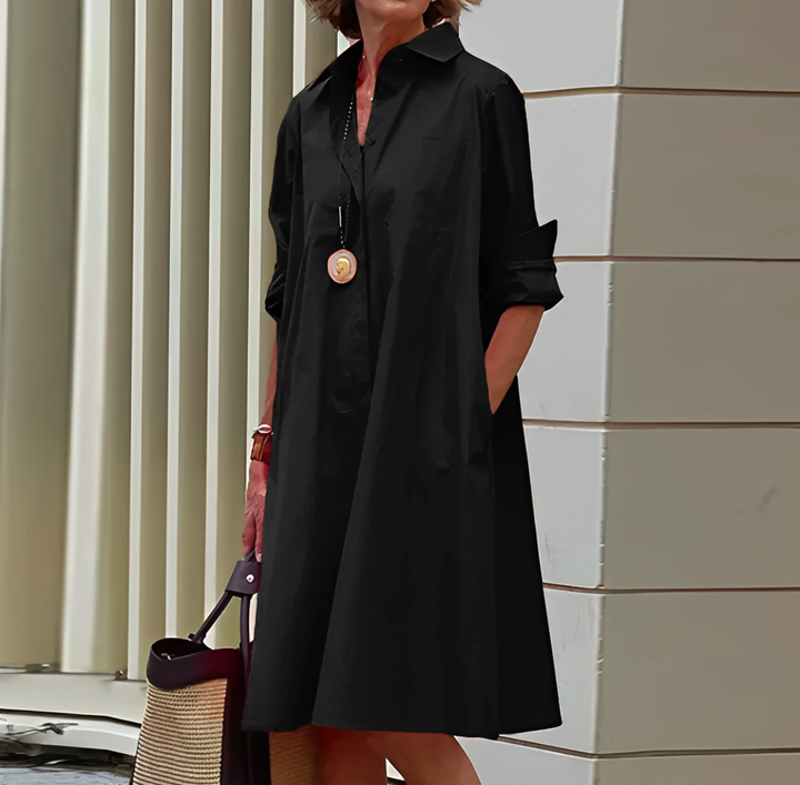 Elegant women's flowy button shirt dress. Midi length, perfect for versatile day to night styling. Work or casual.