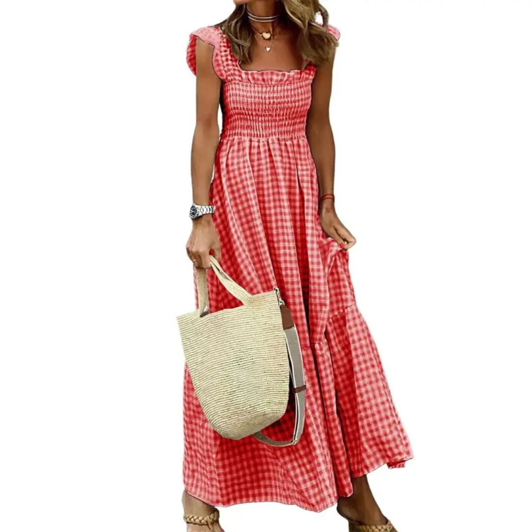 Light green flowy sundress with smocked bodice, ideal for warm weather and beach vacations.