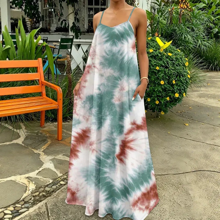 Women's flowy tie-dye maxi dress with thin straps, perfect for summer casual wear or beach vacation.