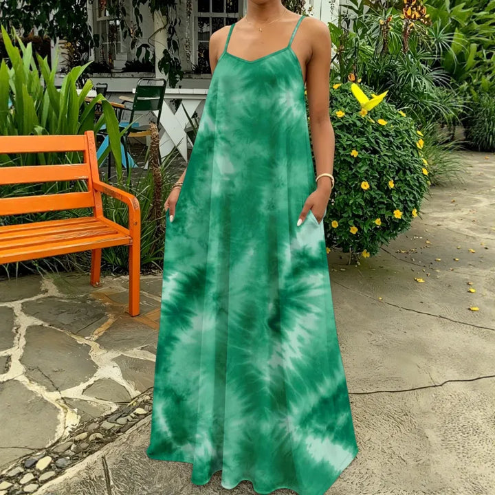 Stylish women's flowy tie-dye strappy maxi dress, capturing a relaxed boho-chic vibe for sunny days.