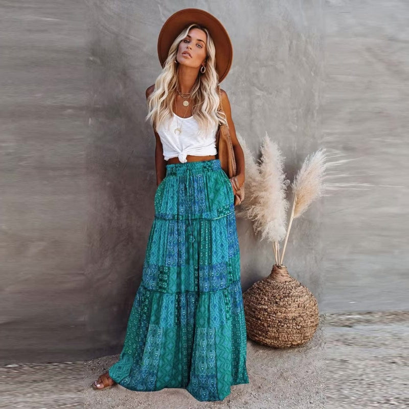 Vibrant tiered floral print maxi skirt, high-waisted A-line silhouette, chic for summer fashion.