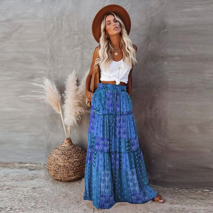 Stylish flowy tiered floral maxi skirt, high waist, great for summer casual wear or beach outings.