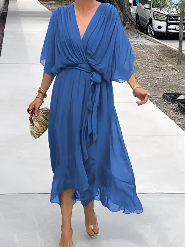 Close-up: V-neck and self-tie belt on an elegant women's flowy maxi dress, ideal for summer style.