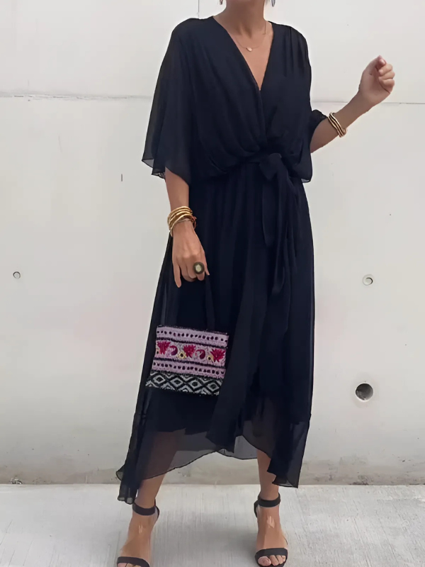 Woman modeling a stylish flowy V-neck belted maxi dress, perfect long summer vacation outfit.